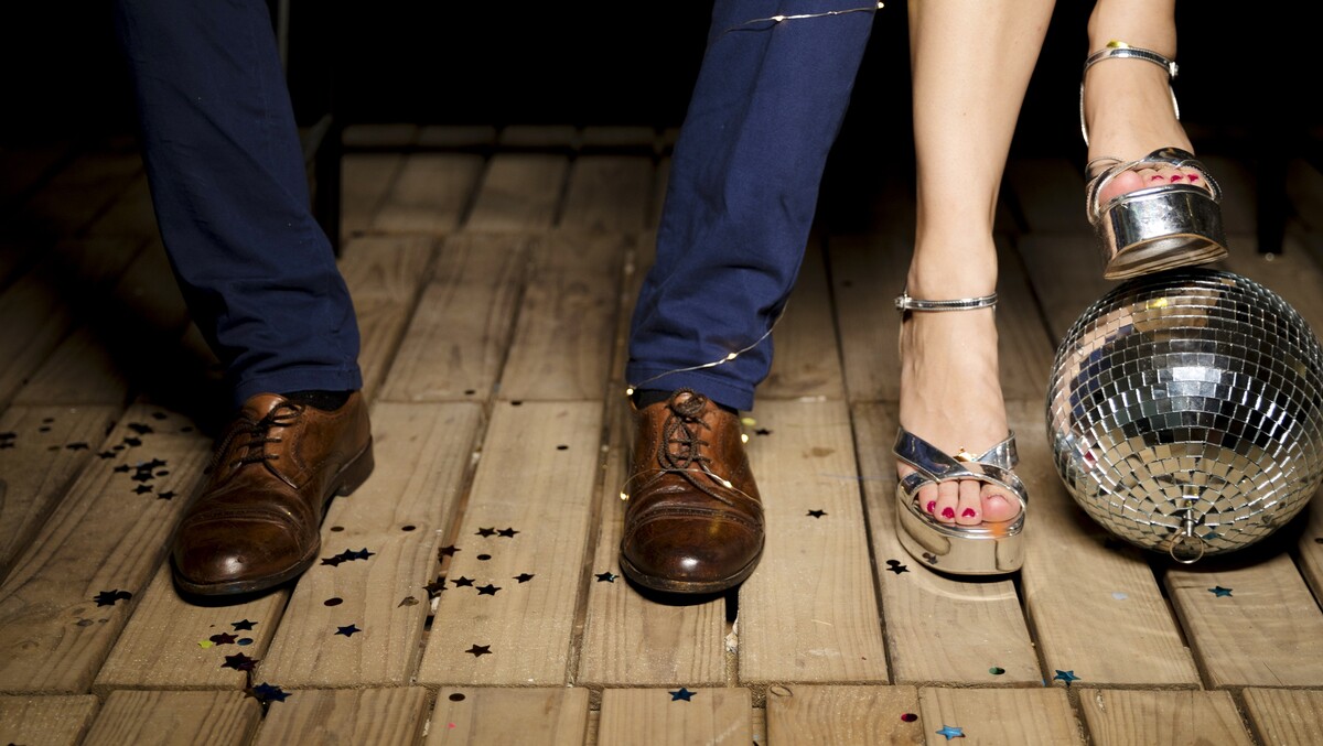 couple standing wooden floor with disco ball
